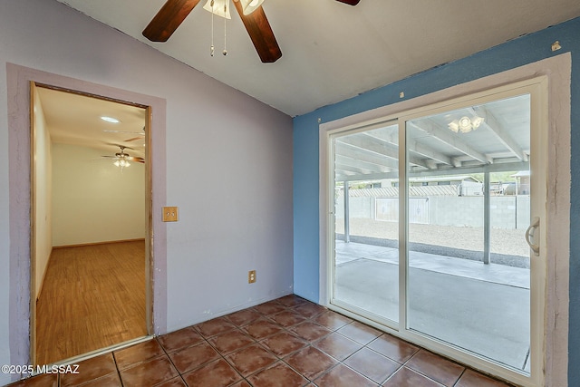 7821 N Jensen Dr, Tucson, AZ 85741 - spare room with a ceiling fan, vaulted ceiling, and tile patterned flooring
