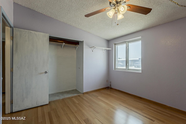 7821 N Jensen Dr, Tucson, AZ 85741 - unfurnished bedroom with a textured ceiling, wood finished floors, a closet, and ceiling fan