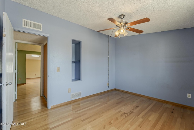 7821 N Jensen Dr, Tucson, AZ 85741 - spare room with a ceiling fan, light wood-type flooring, and a textured ceiling
