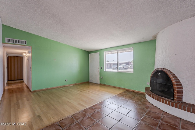 7821 N Jensen Dr, Tucson, AZ 85741 - unfurnished living room with lofted ceiling, a textured ceiling, and tile patterned floors