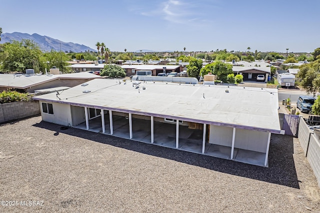 7821 N Jensen Dr, Tucson, AZ 85741 - back of property featuring a mountain view, a fenced backyard, and a residential view