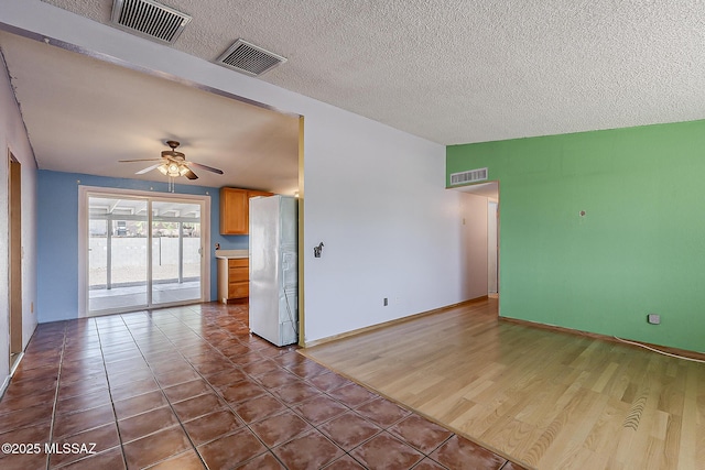 7821 N Jensen Dr, Tucson, AZ 85741 - empty room featuring ceiling fan, tile patterned flooring, and a textured ceiling