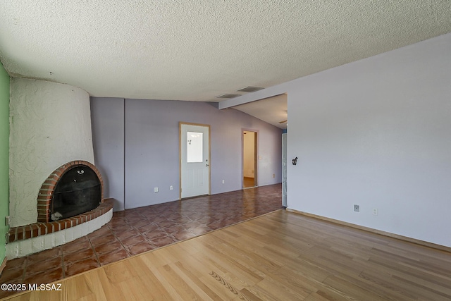7821 N Jensen Dr, Tucson, AZ 85741 - unfurnished living room with wood finished floors, a textured ceiling, and lofted ceiling