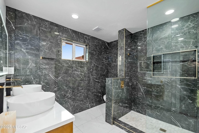 4939 E River Rd, Tucson, AZ 85718 - full bath featuring marble tiled flooring, double vanity, recessed lighting, a marble finish shower, and tile walls