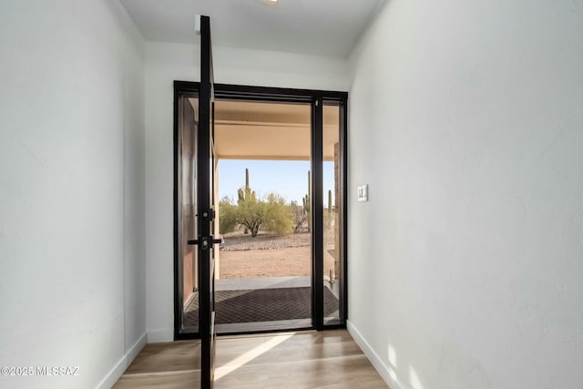 4939 E River Rd, Tucson, AZ 85718 - doorway with wood finished floors and baseboards
