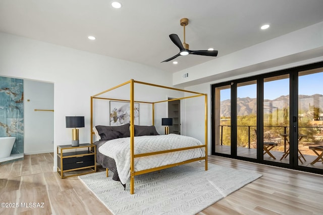 4939 E River Rd, Tucson, AZ 85718 - bedroom with wood finished floors, access to exterior, recessed lighting, baseboards, and a mountain view