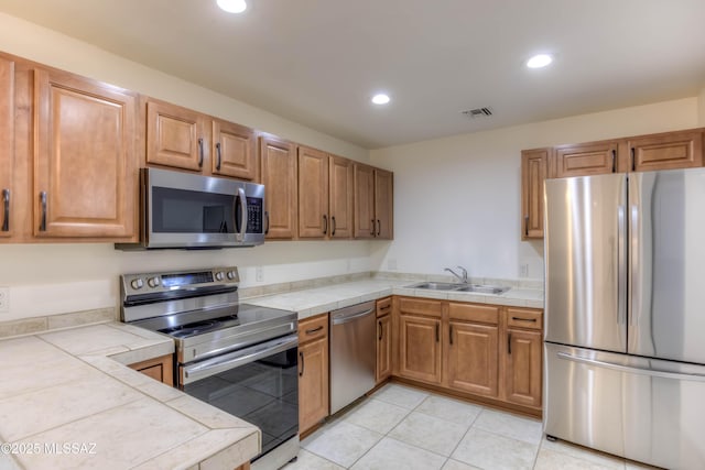 6255 N Camino Pimeria Alta Apt 81, Tucson, AZ 85718 - kitchen with appliances with stainless steel finishes, a sink, tile countertops, recessed lighting, and light tile patterned flooring