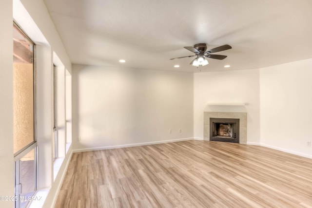 6255 N Camino Pimeria Alta Apt 81, Tucson, AZ 85718 - unfurnished living room featuring a ceiling fan, light wood finished floors, recessed lighting, a fireplace, and baseboards
