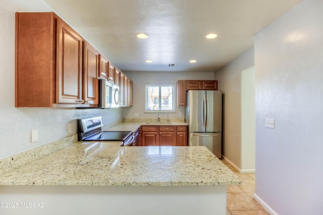 6255 N Camino Pimeria Alta Apt 65, Tucson, AZ 85718 - kitchen with appliances with stainless steel finishes, recessed lighting, a sink, light tile patterned floors, and light stone counters