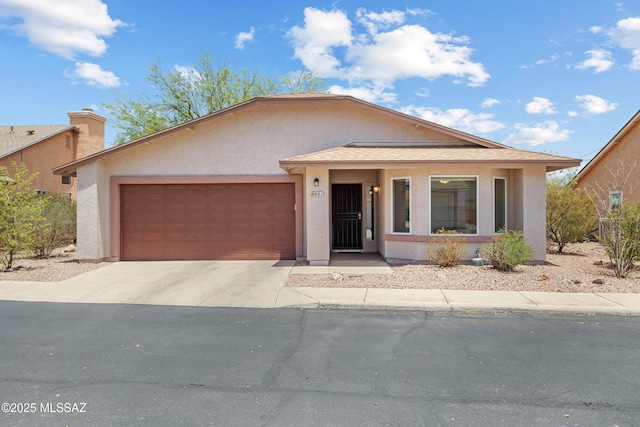 8051 E Calle De Camacho, Tucson, AZ 85715 - view of front of house featuring concrete driveway, an attached garage, and stucco siding