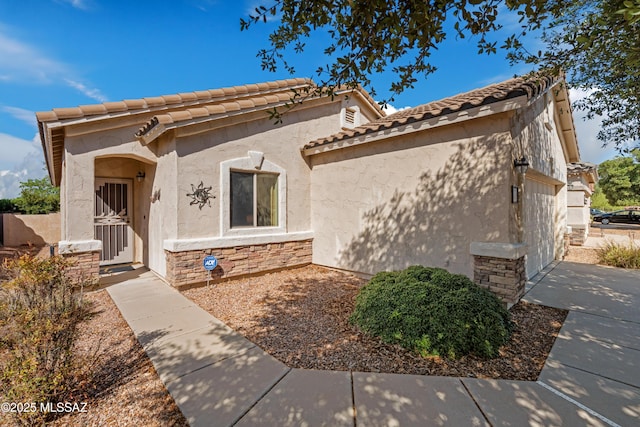 1248 W Via Cerro Colorado, Sahuarita, AZ 85629 - view of front of property with stone siding, stucco siding, an attached garage, and a tiled roof