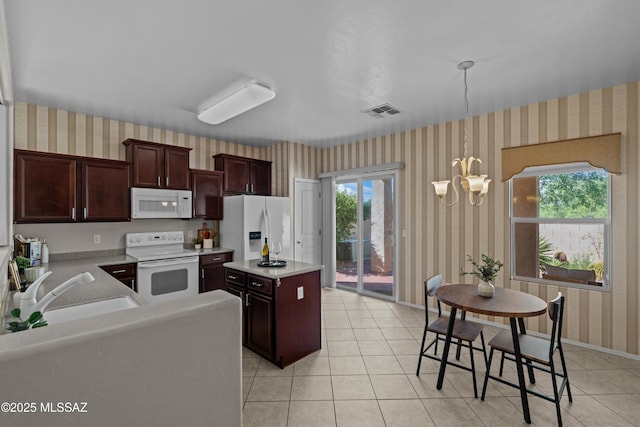 1248 W Via Cerro Colorado, Sahuarita, AZ 85629 - kitchen with white appliances, wallpapered walls, a sink, light countertops, and a kitchen island