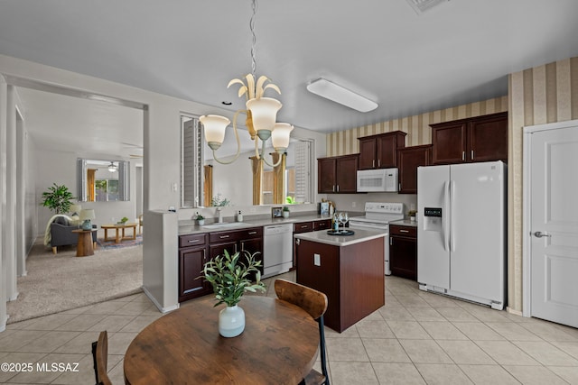 1248 W Via Cerro Colorado, Sahuarita, AZ 85629 - kitchen featuring white appliances, light tile patterned flooring, light countertops, a sink, and a kitchen island