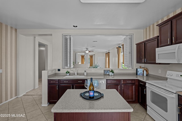 1248 W Via Cerro Colorado, Sahuarita, AZ 85629 - kitchen with white appliances, a sink, wallpapered walls, light tile patterned flooring, and a kitchen island