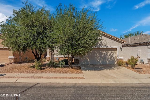 1248 W Via Cerro Colorado, Sahuarita, AZ 85629 - view of front of property featuring an attached garage, driveway, stucco siding, and a tiled roof