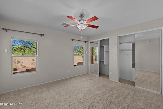 1248 W Via Cerro Colorado, Sahuarita, AZ 85629 - unfurnished bedroom featuring multiple closets, carpet floors, a ceiling fan, and baseboards