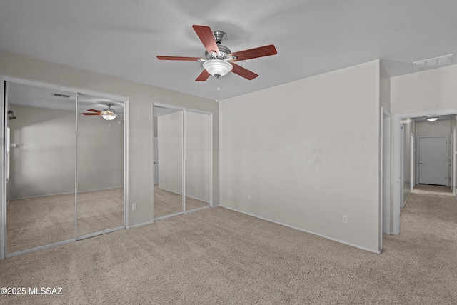 1248 W Via Cerro Colorado, Sahuarita, AZ 85629 - unfurnished bedroom featuring two closets, carpet, a ceiling fan, and baseboards