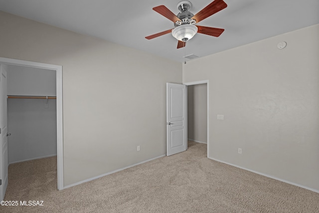1248 W Via Cerro Colorado, Sahuarita, AZ 85629 - unfurnished bedroom featuring carpet flooring, a walk in closet, baseboards, a closet, and ceiling fan