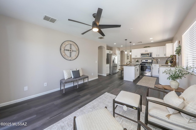 Tucson, AZ 85748 - living room featuring arched walkways, dark wood finished floors, ceiling fan, baseboards, and recessed lighting