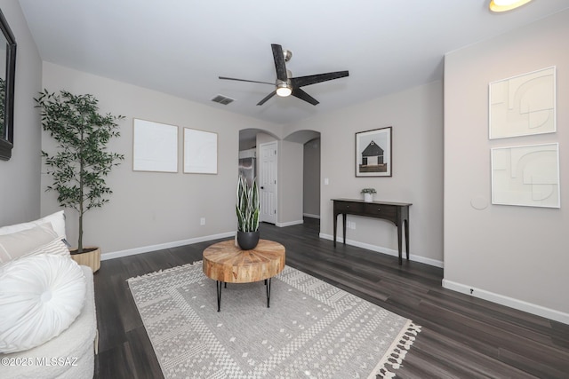 Tucson, AZ 85748 - living room featuring arched walkways, dark wood-style flooring, a ceiling fan, and baseboards
