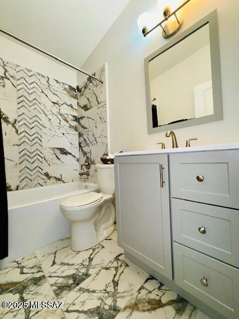 7122 E Eastland St, Tucson, AZ 85710 - full bath with toilet, vanity, marble finish floors,  shower combination, and vaulted ceiling