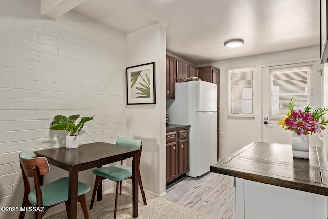 134 S Paseo Quinta Unit A, Green Valley, AZ 85614 - kitchen featuring freestanding refrigerator, dark countertops, and light wood-style flooring