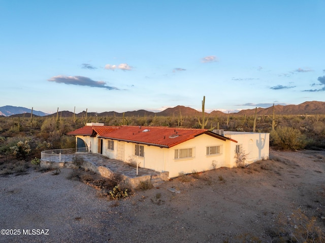 5730 N Tula Ln, Tucson, AZ 85743 - rear view of house featuring a mountain view, a tile roof, and stucco siding