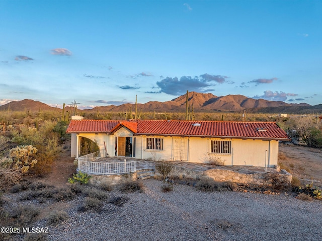 5730 N Tula Ln, Tucson, AZ 85743 - mediterranean / spanish home featuring a tile roof, a mountain view, and a chimney