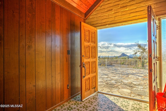 5730 N Tula Ln, Tucson, AZ 85743 - entrance foyer with vaulted ceiling, plenty of natural light, wooden walls, tile patterned floors, and a mountain view