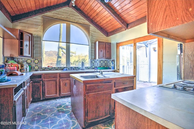 5730 N Tula Ln, Tucson, AZ 85743 - kitchen with wood ceiling, a sink, a kitchen island with sink, light countertops, and backsplash
