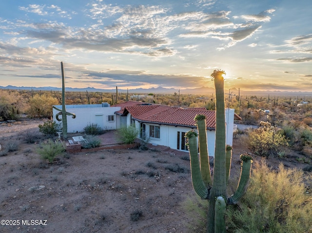 5730 N Tula Ln, Tucson, AZ 85743 - view of front facade with a tile roof, a mountain view, and stucco siding