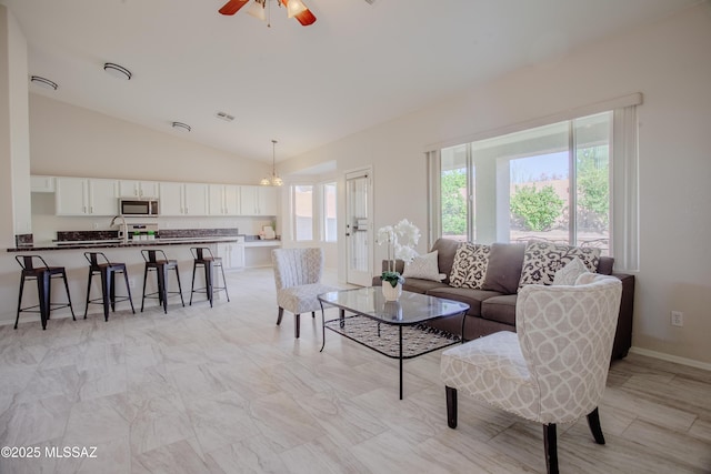 7663 W Creosote Spring Ct, Tucson, AZ 85743 - living area with lofted ceiling, ceiling fan, baseboards, and a chandelier