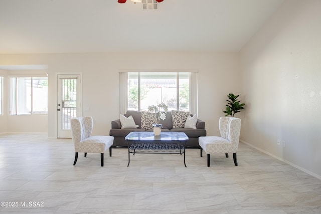 7663 W Creosote Spring Ct, Tucson, AZ 85743 - living room with healthy amount of natural light, ceiling fan, and baseboards