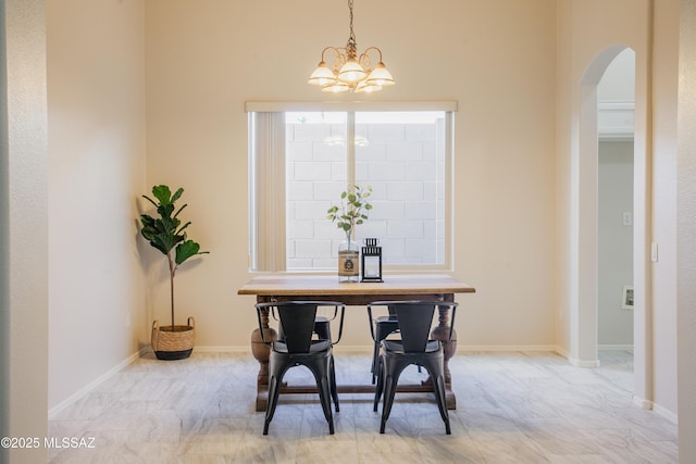 7663 W Creosote Spring Ct, Tucson, AZ 85743 - dining space with arched walkways and a chandelier