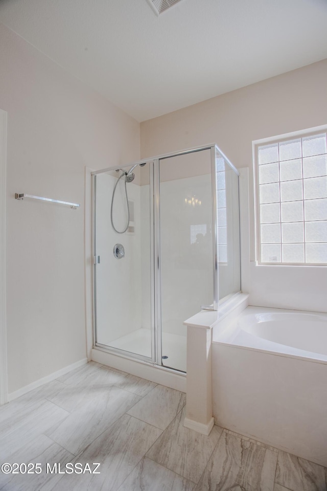 7663 W Creosote Spring Ct, Tucson, AZ 85743 - bathroom with a shower stall, a bath, and baseboards