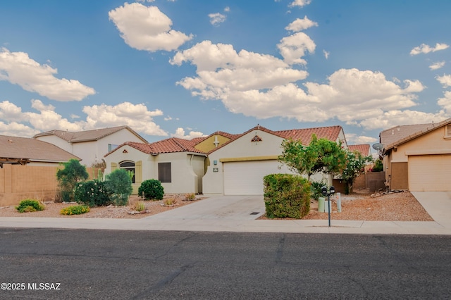 7663 W Creosote Spring Ct, Tucson, AZ 85743 - mediterranean / spanish house with concrete driveway, stucco siding, a tiled roof, and a garage