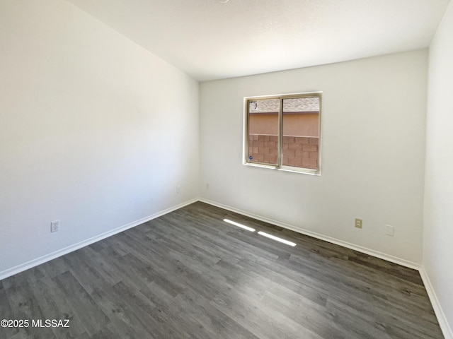 8233 E Sundew Dr, Tucson, AZ 85710 - empty room with dark wood-style flooring and baseboards