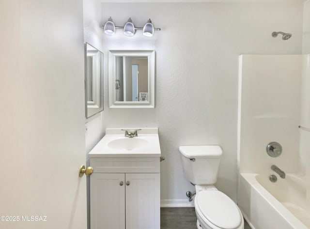8233 E Sundew Dr, Tucson, AZ 85710 - bathroom with toilet, vanity, bathing tub / shower combination, and baseboards