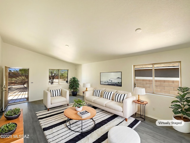 8233 E Sundew Dr, Tucson, AZ 85710 - living area featuring wood finished floors, baseboards, and vaulted ceiling