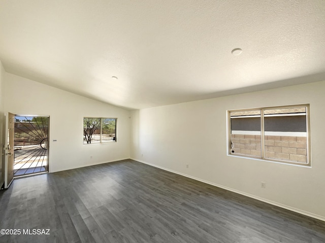 8233 E Sundew Dr, Tucson, AZ 85710 - unfurnished room featuring dark wood-type flooring, baseboards, and vaulted ceiling