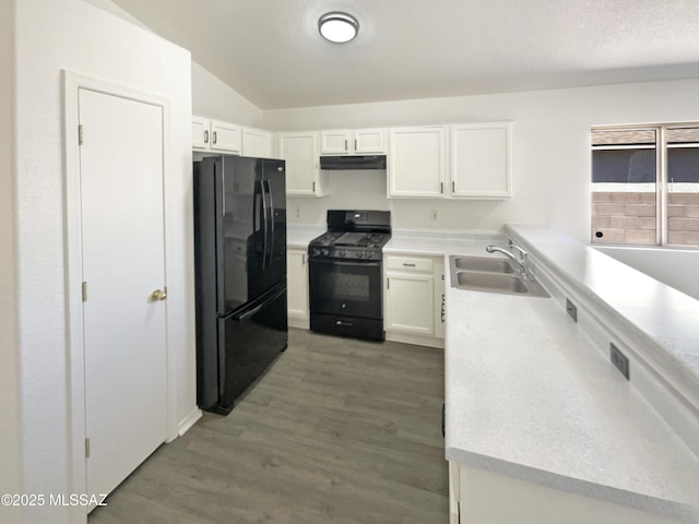 8233 E Sundew Dr, Tucson, AZ 85710 - kitchen featuring black appliances, a sink, under cabinet range hood, light countertops, and lofted ceiling