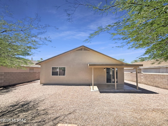 8233 E Sundew Dr, Tucson, AZ 85710 - rear view of house featuring a fenced backyard, stucco siding, and a patio area