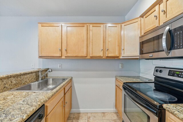 961 N Euclid Ave Unit 130, Tucson, AZ 85719 - kitchen featuring stainless steel appliances, light brown cabinetry, a sink, baseboards, and light stone countertops