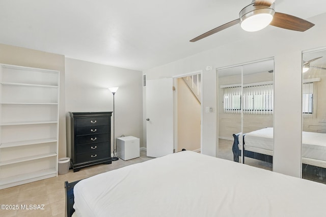 961 N Euclid Ave Unit 130, Tucson, AZ 85719 - bedroom featuring multiple closets, a ceiling fan, and light tile patterned floors