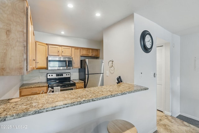 961 N Euclid Ave Unit 130, Tucson, AZ 85719 - kitchen with stainless steel appliances, a peninsula, light stone countertops, recessed lighting, and tasteful backsplash