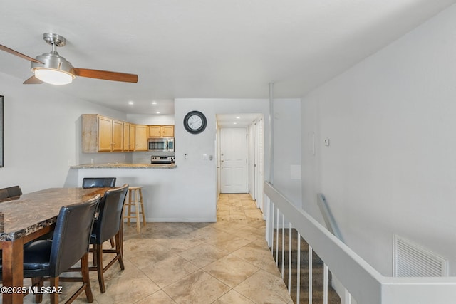 961 N Euclid Ave Unit 130, Tucson, AZ 85719 - kitchen featuring stainless steel microwave, recessed lighting, light brown cabinetry, a ceiling fan, and baseboards