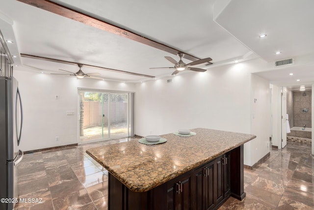 3940 E Timrod St Unit 118, Tucson, AZ 85711 - kitchen with a ceiling fan, freestanding refrigerator, marble tiled floors, a center island, and recessed lighting
