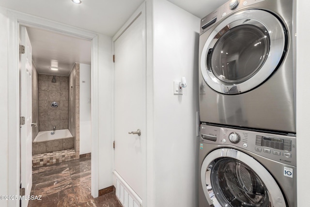 3940 E Timrod St Unit 118, Tucson, AZ 85711 - washroom featuring stacked washer and clothes dryer and marble finish flooring