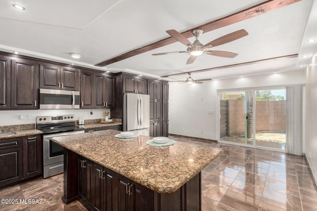 3940 E Timrod St Unit 118, Tucson, AZ 85711 - kitchen featuring stainless steel appliances, dark marble finish floors, a ceiling fan, a center island, and stone counters