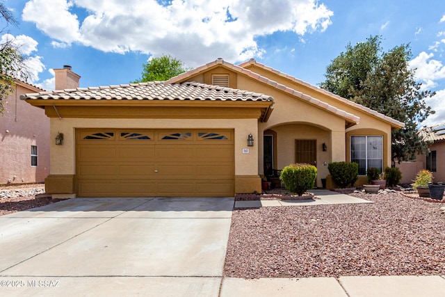 7157 W Odyssey Way, Tucson, AZ 85743 - mediterranean / spanish-style house with stucco siding, driveway, an attached garage, and a tile roof